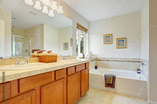 Bathroom with honey tone vanity cabinet