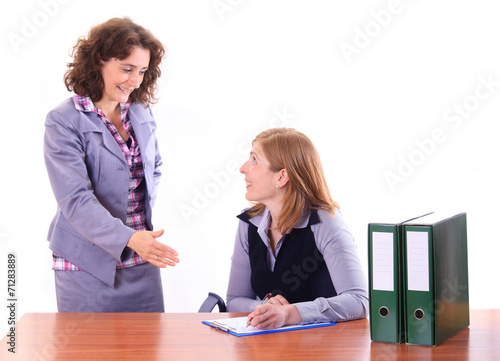 Boss woman explaing to her assistant happily photo