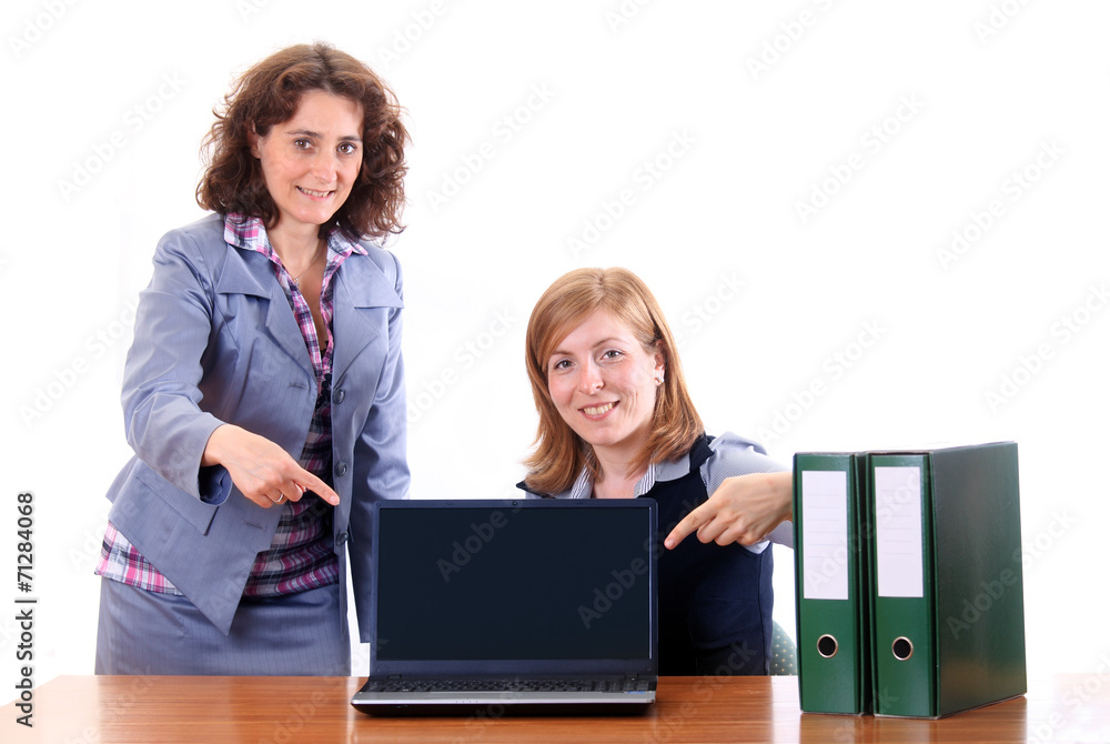 Two women showing display of notebook Two women showing display of notebook