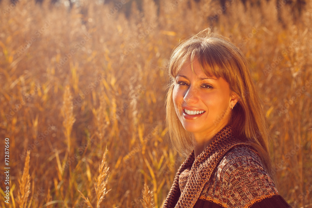 Young beautiful autumn woman lighted by the sun Young beautiful autumn woman lighted by the sun