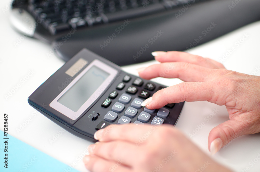 Woman's hand using a calculator Woman's hand using a calculator