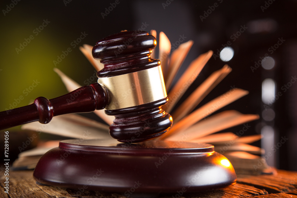 Wooden gavel and books on wooden table, law concept Wooden gavel and books on wooden table, law concept
