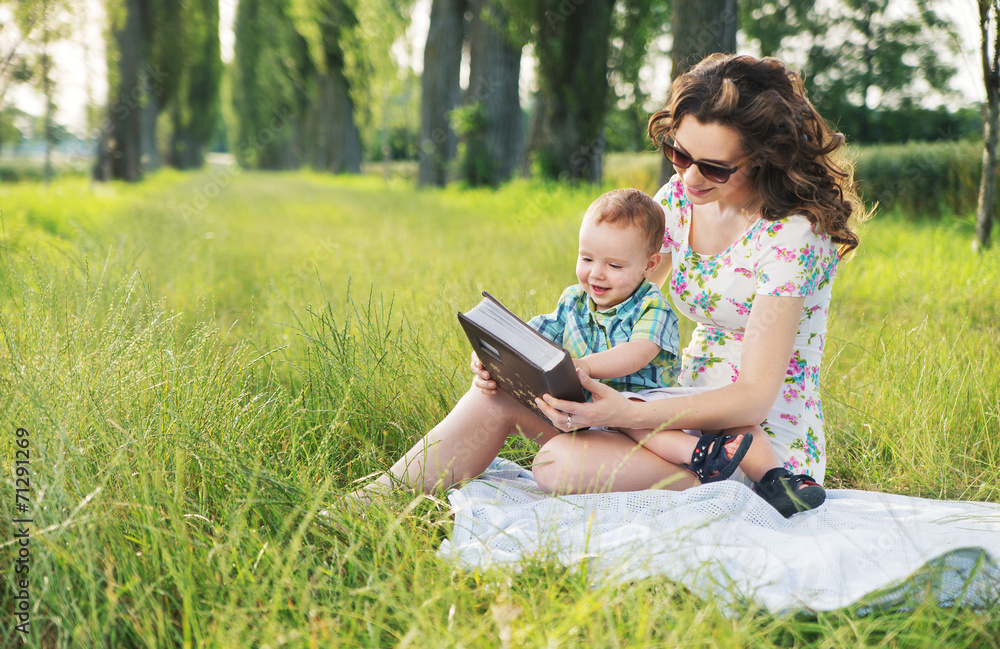 Mother with curly hairstyle reading fairy tales for baby Mother with curly hairstyle reading fairy tales for baby