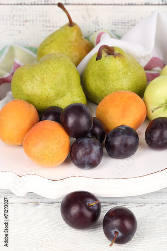 Ripe fruits on table on wooden background