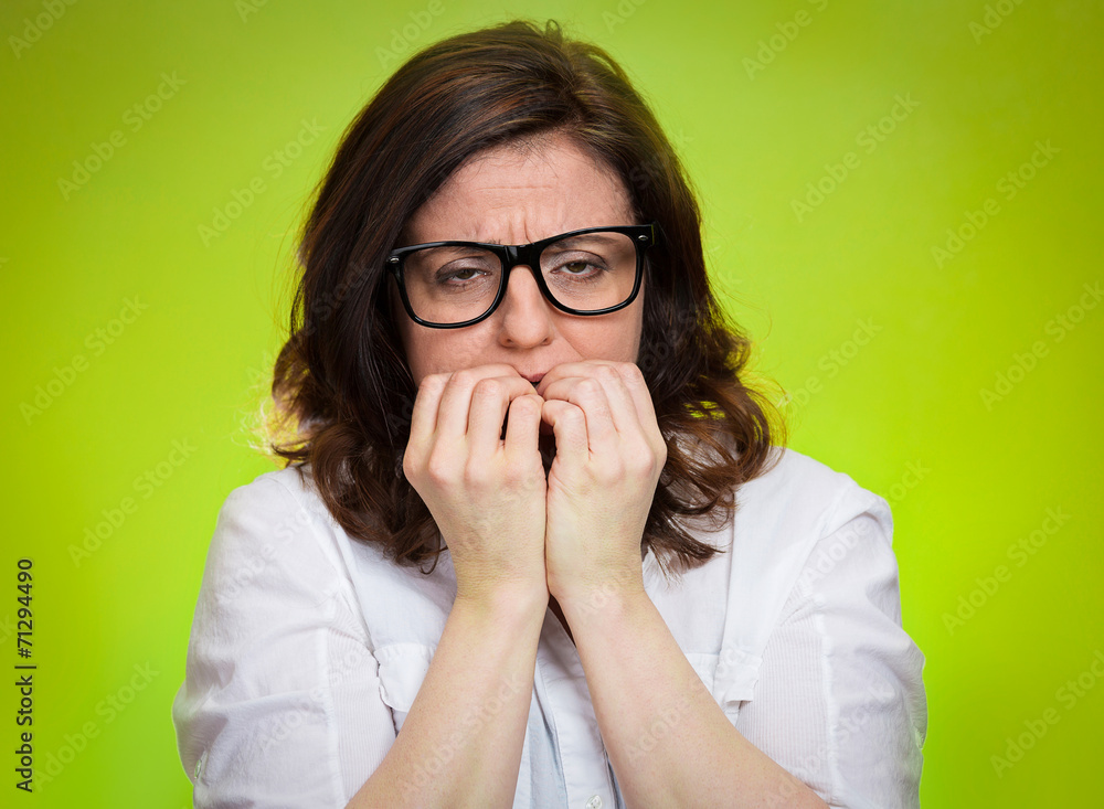 Headshot nervous, stressed woman green background Headshot nervous, stressed woman green background