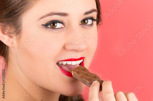 pretty young girl eating chocolate