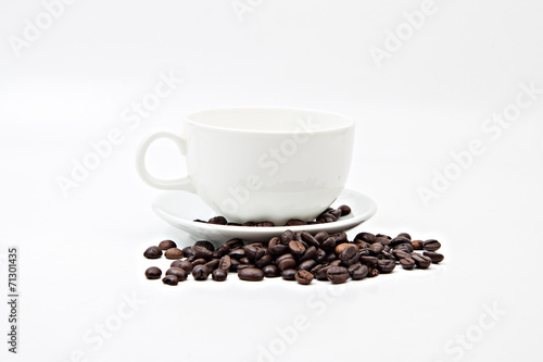 Brown coffee beans and coffee cup isolated on white background