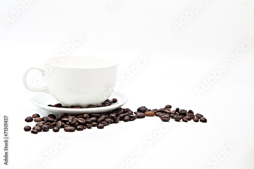 Brown coffee beans and coffee cup isolated on white background