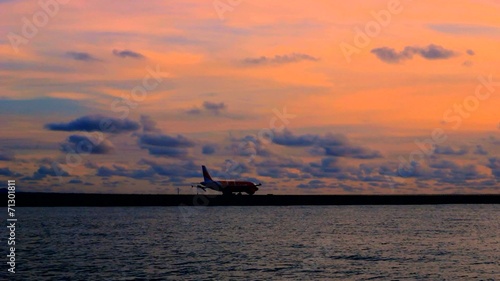 Airplane (Aeroplane) Taxing Along Runway at Dusk