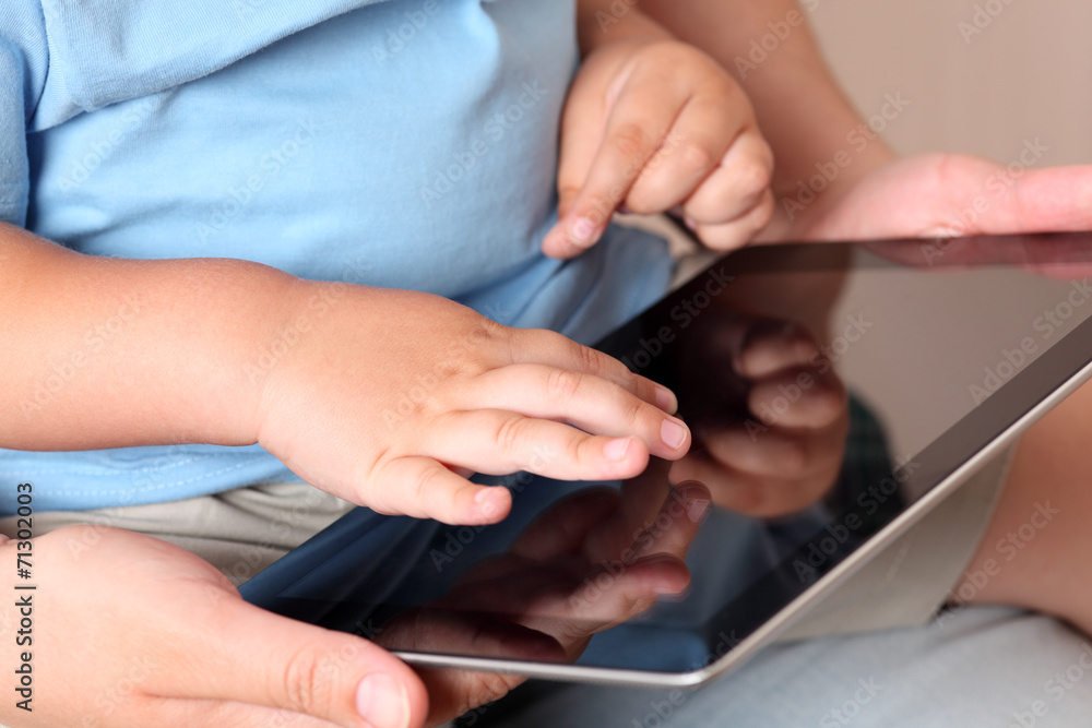 Child and mother using a digital tablet