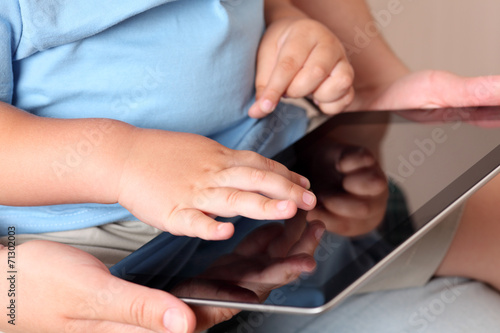 Child and mother using a digital tablet