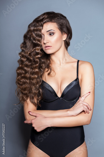 Portrait of a young brunette woman with beautiful hair © A.Kazak