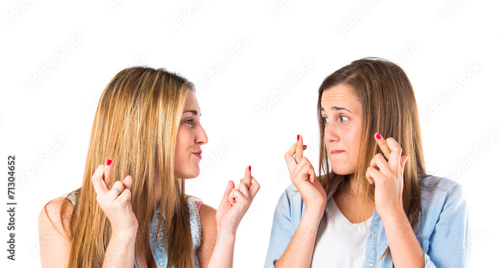 Girls with her fingers crossing over white background Girls with her fingers crossing over white background