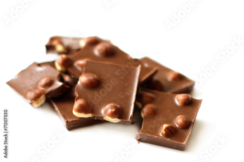 Chocolate pieces with nuts on white background