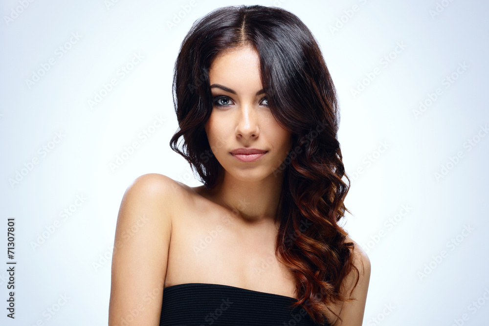 Portrait of a young attractive woman over blue background