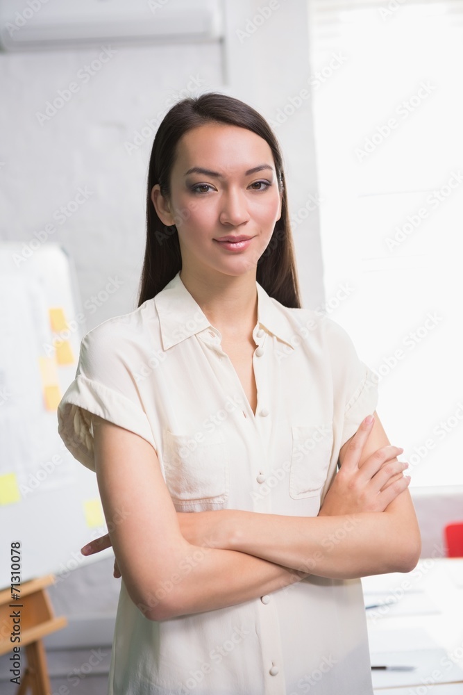 Confident businesswoman with arms crossed in office Confident businesswoman with arms crossed in office