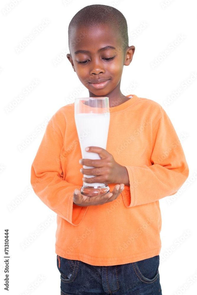 Cute boy smiling and holding glass of milk Cute boy smiling and holding glass of milk