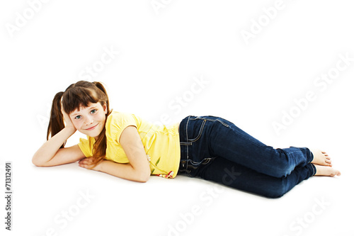 Fotografía Pretty little girl lying on the floor in jeans