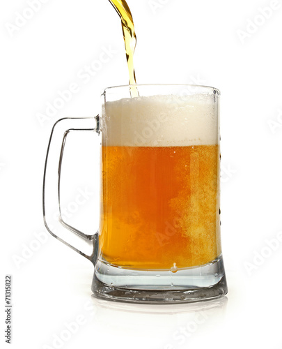 pouring beer in mug isolated on white