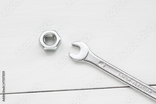 close up of wrench and screw nut at white background © atomicrooster