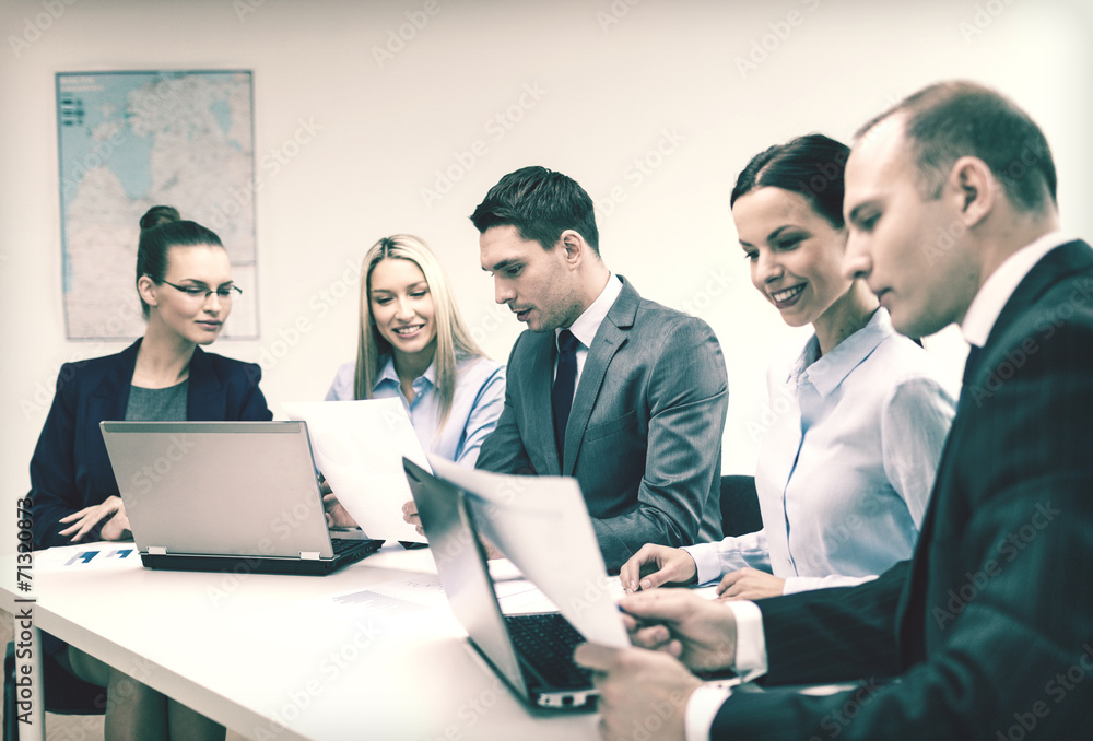 business team with laptop having discussion business team with laptop having discussion