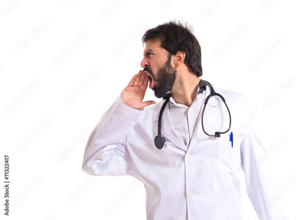 Doctor shouting over isolated white background Doctor shouting over isolated white background