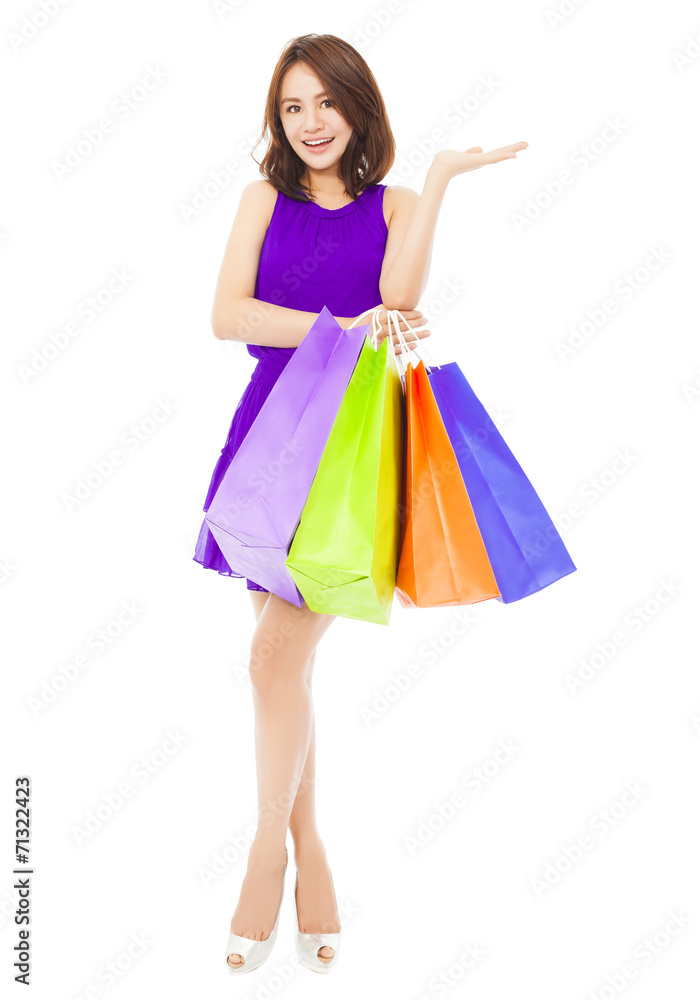 young woman holding shopping bags and hand gesture young woman holding shopping bags and hand gesture