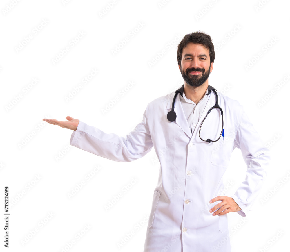 Doctor presenting something over isolated white background Doctor presenting something over isolated white background