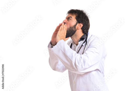 Doctor shouting over isolated white background