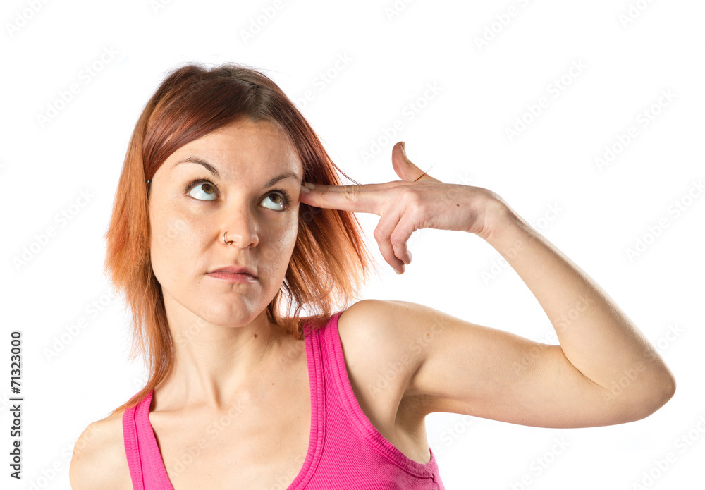 Girl making suicide gesture over white background Girl making suicide gesture over white background