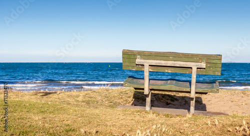 The beautiful view of bench on grass looking out toward the ocea