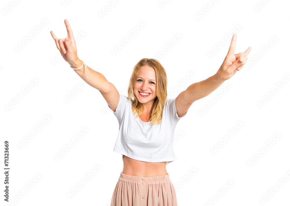 Girl making horn gesture over white background Girl making horn gesture over white background