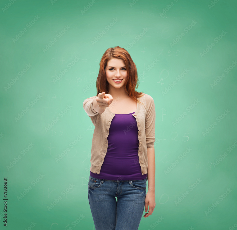 smiling teenage girl pointing finger at you smiling teenage girl pointing finger at you