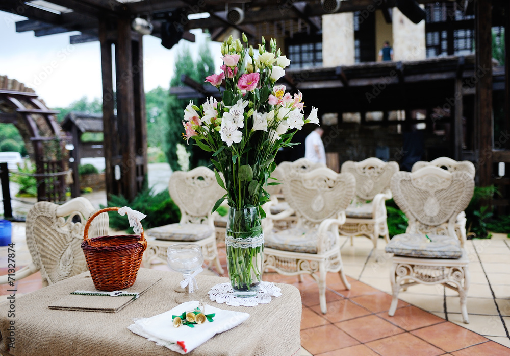 delicate wedding bouquet in a vase on the table. Away ceremony R delicate wedding bouquet in a vase on the table. Away ceremony R
