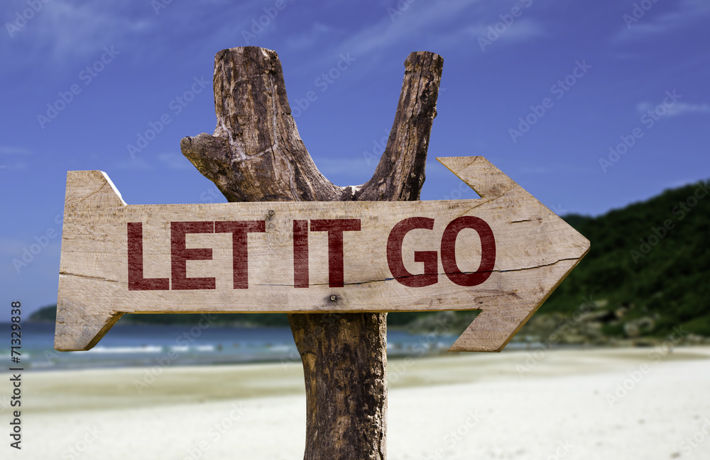 Let It Go wooden sign with a beach on background