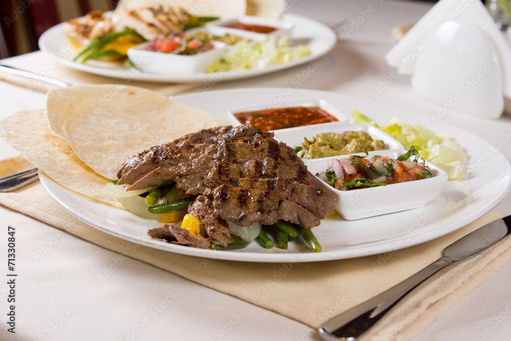 Grilled Steak Fajitas with Fixings on Plate Grilled Steak Fajitas with Fixings on Plate