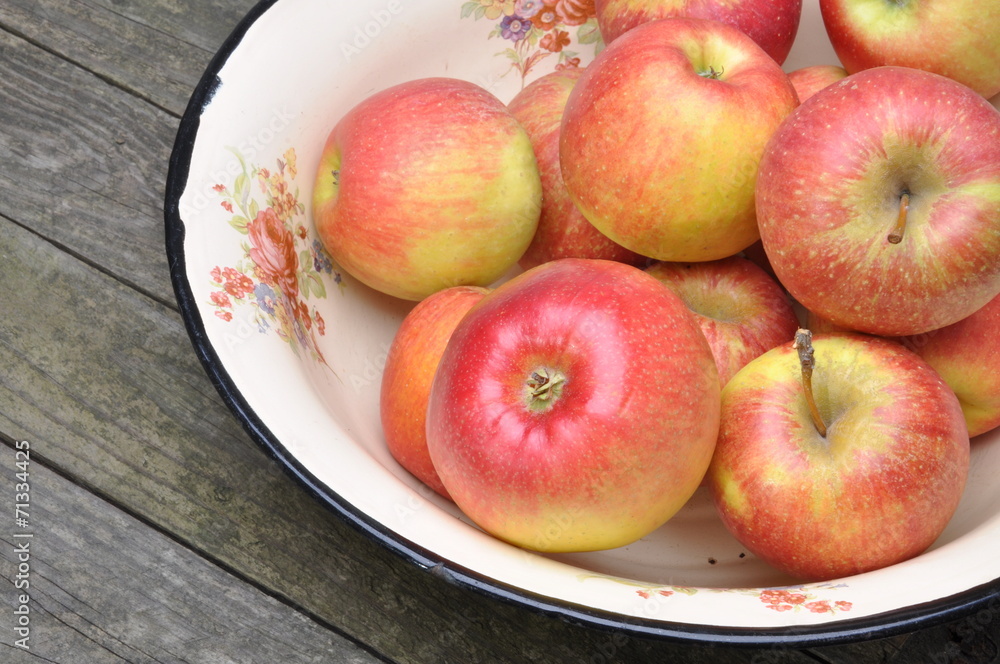 Fresh apples in metal bowl on wooden table Fresh apples in metal bowl on wooden table