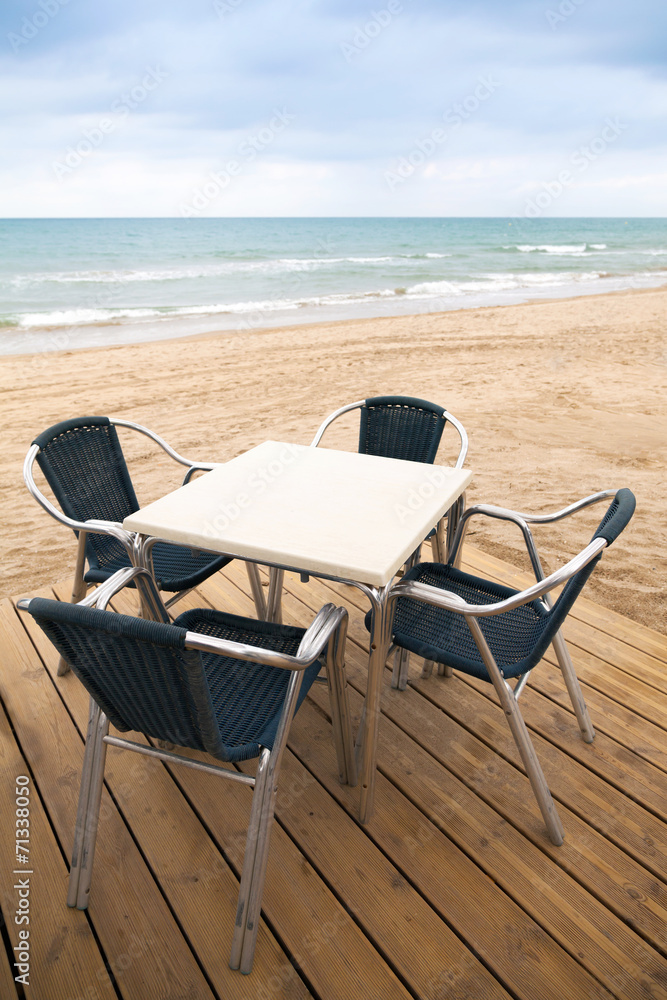 Sea side bar interior with wooden floor and armchairs Sea side bar interior with wooden floor and armchairs