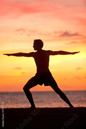 Fototapeta Naklejka Na Ścianę i Meble -  Yoga man training and meditating in warrior pose