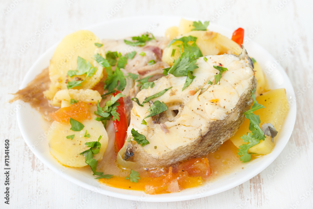 fish stew on white plate on white background