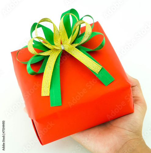 Red gift box in hand isolated, christmas theme photo