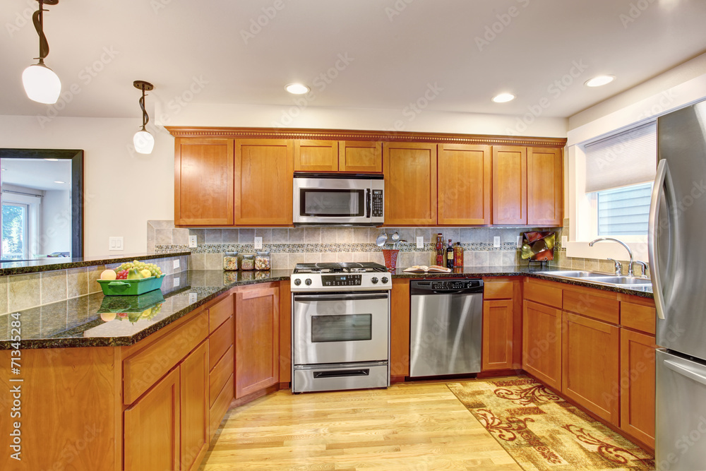 Maple kitchen cabinets with steel appliances and granite tops Maple kitchen cabinets with steel appliances and granite tops