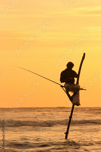 Silhouette of a stick fisherman at sunset, Unawatuna, Sri Lanka
