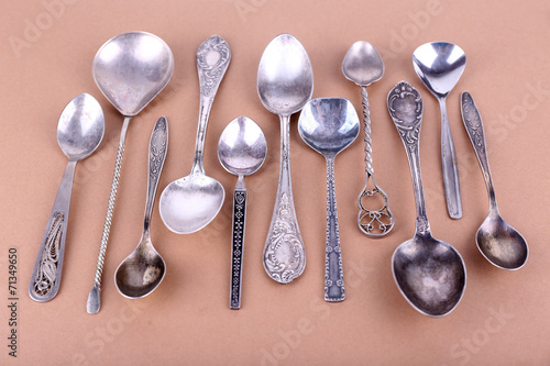 Metal spoons on brown paper background