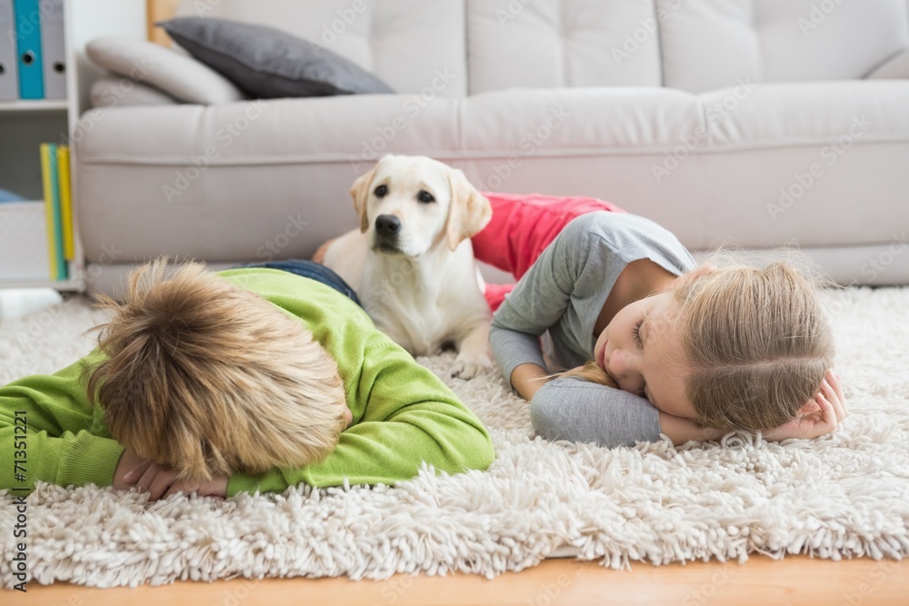 Cute silblings with their puppy on rug Stock Photo Adobe Stock