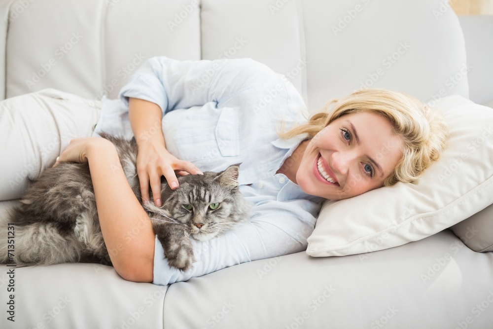 Happy blonde with pet cat on sofa Happy blonde with pet cat on sofa