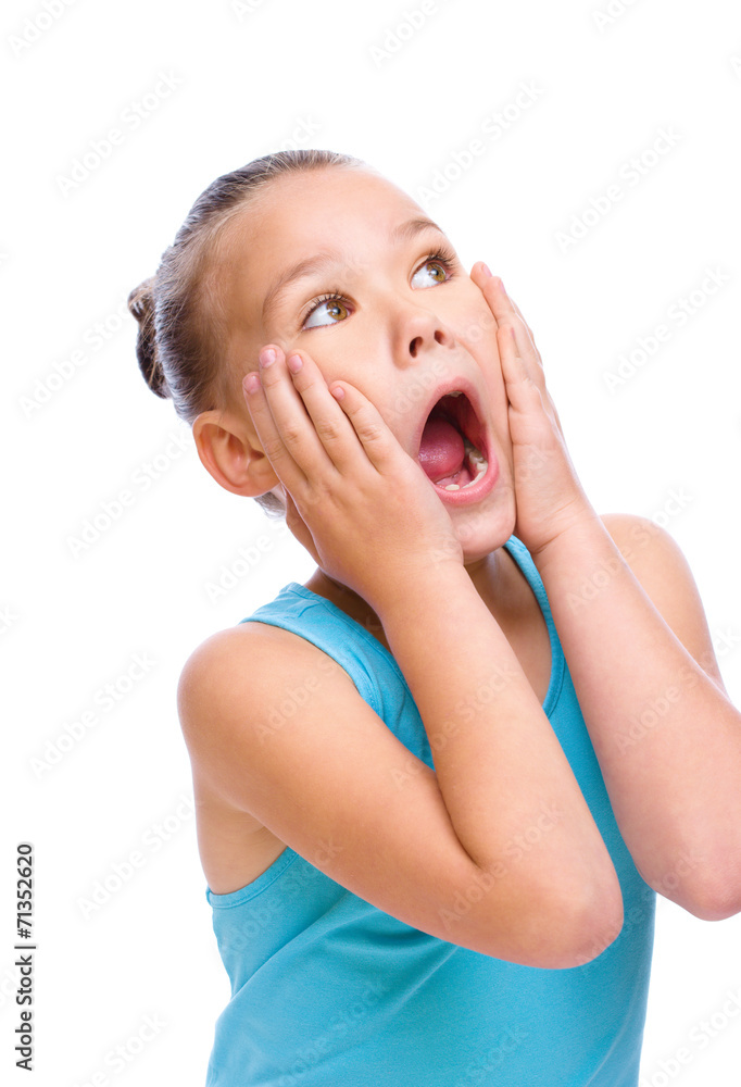 Cute girl is holding her face in astonishment Cute girl is holding her face in astonishment