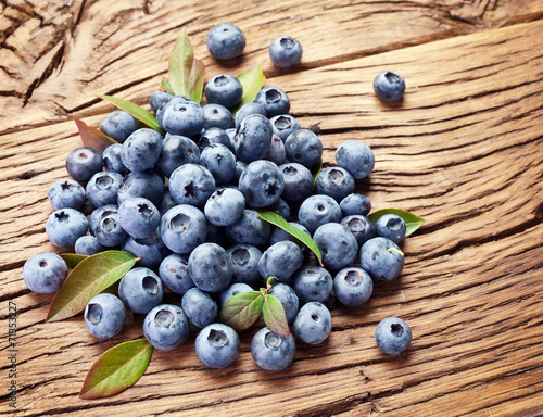 Blueberries over old wooden table.