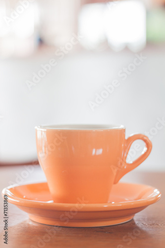 Orange mug on wooden table