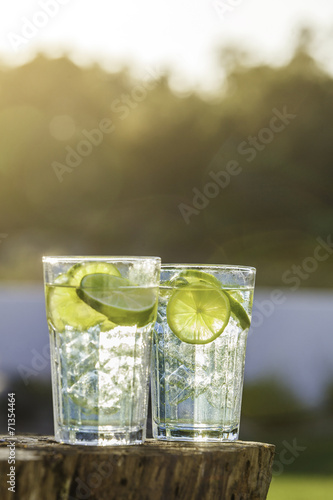 A glass of Lemon Lime soda filled with ice cubes, soda